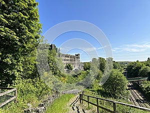 Large derelict mill, close to the Rochdale train line in, Littleborough, Lancashire, UK