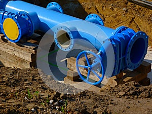 large diameter blue water pipe installation in excavated ditch