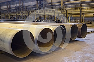 Large diameter pipes are in an industrial workshop