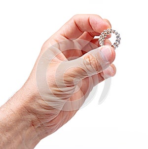 Large diamond ring on the hand on a male adult