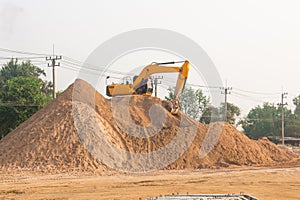 Large diesel mechanical excavator digging earth machine at excavation working in road construction