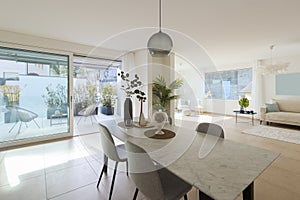 Large dining room and large living room. All in the same space. Nice marble table with four chairs. Very warm and cosy space