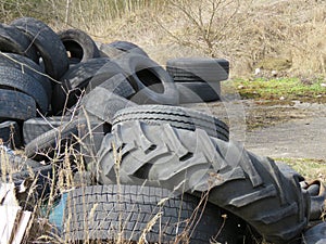 Large discarded rubber tires. Garbage in nature.
