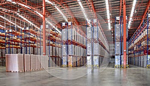 Large distribution warehouse full of cargo stack on rack system.