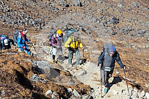 Large Diverse Group of People walking up on rocky Trail