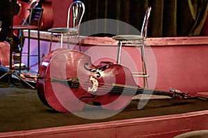 large double bass lying on the theater stage during intermission