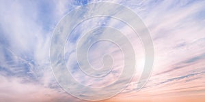 Large dramatic pastel colored cloudscape at sunset