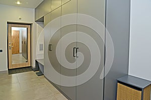 Large dressing room in the corridor with mirrored entrance door