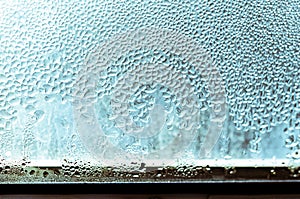 Large drops of condensate on a metal-plastic window. Dew point. Plastic