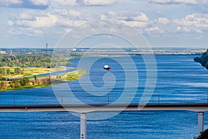 Large dry cargo ship with a black hull anchored along the big river