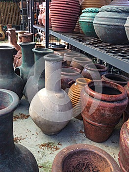 Large earthenware pots and chimeneas at an outdoor market photo