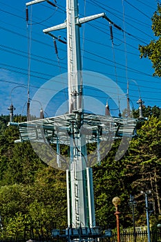 Large electrical tower in densely wooded area
