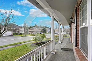 Large elegant side porch photo with view of the street