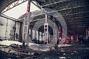 Large empty abandoned warehouse building or factory workshop, abstract ruins background