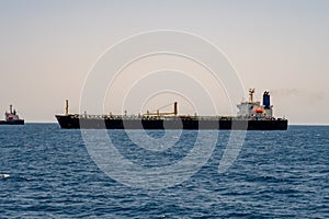 Large empty containter ship without cargo entering harbor in Port Sudan with a tugboat. Sudan, Red Sea