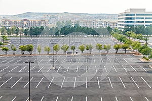 Large Empty Parking Lot with One White Car