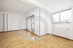 Large empty room with access to a terrace with windows and light