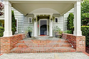 Large entrance porch with columns and brick trim