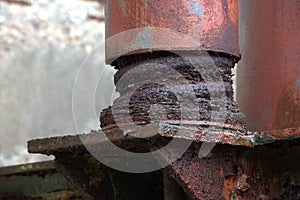 Large eroded shock absorber, vibration damper in a disused factory