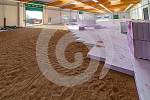 A large factory building, purple insulation panels are laid on the floor