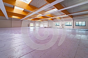 a large factory building, purple insulation panels are laid on the floor