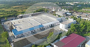 Large factory in an ecologically clean region. Big factory top view. A modern plant in a rural area drone view.