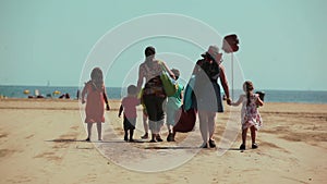 Large family with children walks to the sea