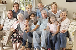 Large Family Group Sitting On Sofa Indoors photo