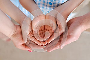 Large family holds palms their hands together, concept happiness in the family