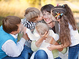 Large family hugging and having fun outdoors.