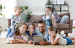Large family mother, father and children with tablet computer at home
