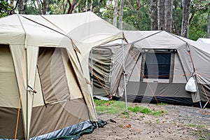 Large family tents on a campsite campground. Group camping vacation. Family camping