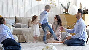 Large family with three children is having fun at home in Christmas eve