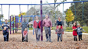 Large Family at Park on Swingset photo