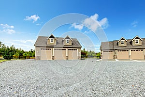 Large farm country house with gravel driveway and green landscape. photo