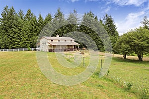 Large farm field with empty horse barn