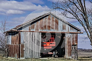 Large Farm Tractor Inside Rustic Shed