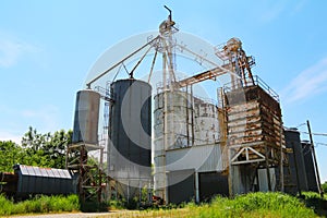 Large farming community co-op agricultural feed grain and corn silo and elevator building against a blue sky in rural america