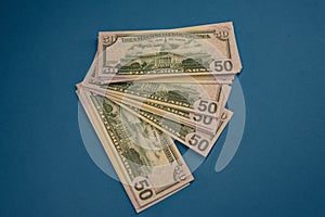 Large Fat Money Roll Isolated on a blue Background