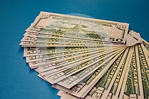 Large Fat Money Roll Isolated on a blue Background