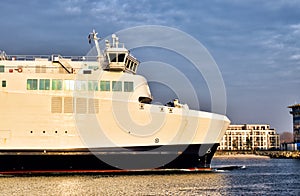 A large ferry vessel enters the port of Rostock Germany