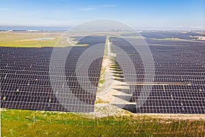 A large field of solar panels is shown in the image aerial view image