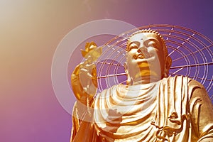 A large figure of a seated golden buddha