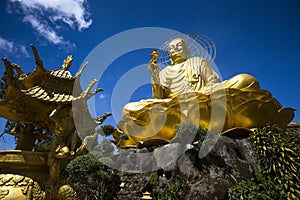 A large figure of a seated golden buddha