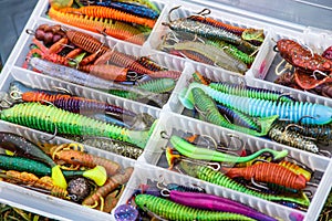 A large fisherman`s tackle box fully stocked with lures and gear for fishing.fishing lures and accessories in the box background