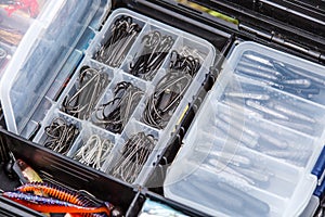 A large fisherman`s tackle box fully stocked with lures and gear for fishing.fishing lures and accessories in the box background