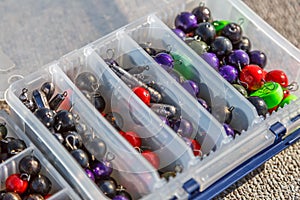 A large fisherman`s tackle box fully stocked with lures and gear for fishing.fishing lures and accessories in the box background