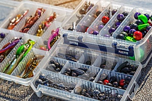 A large fisherman`s tackle box fully stocked with lures and gear for fishing.fishing lures and accessories in the box background