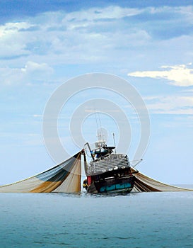 A large fishing boat in the middle of the sea.