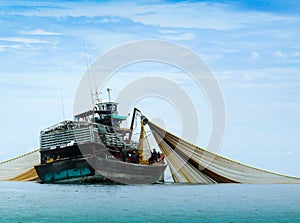 A large fishing boat in the middle of the sea.